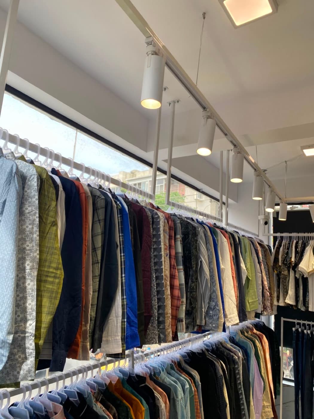 A long rail of men's printed and checked shirts