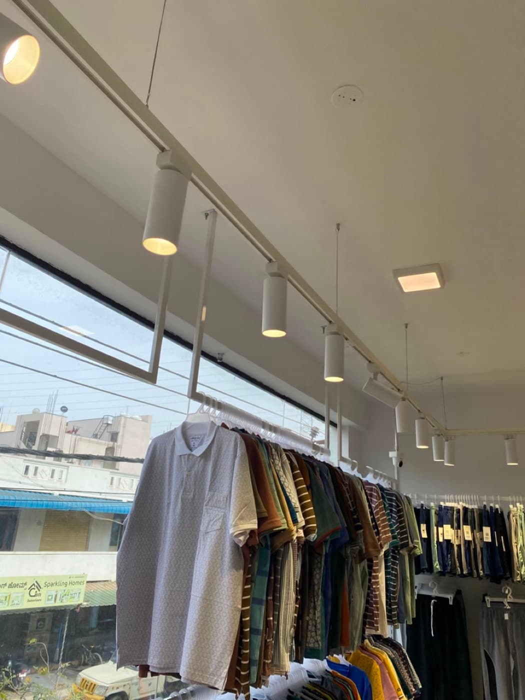 Polo shirts on display under track lighting